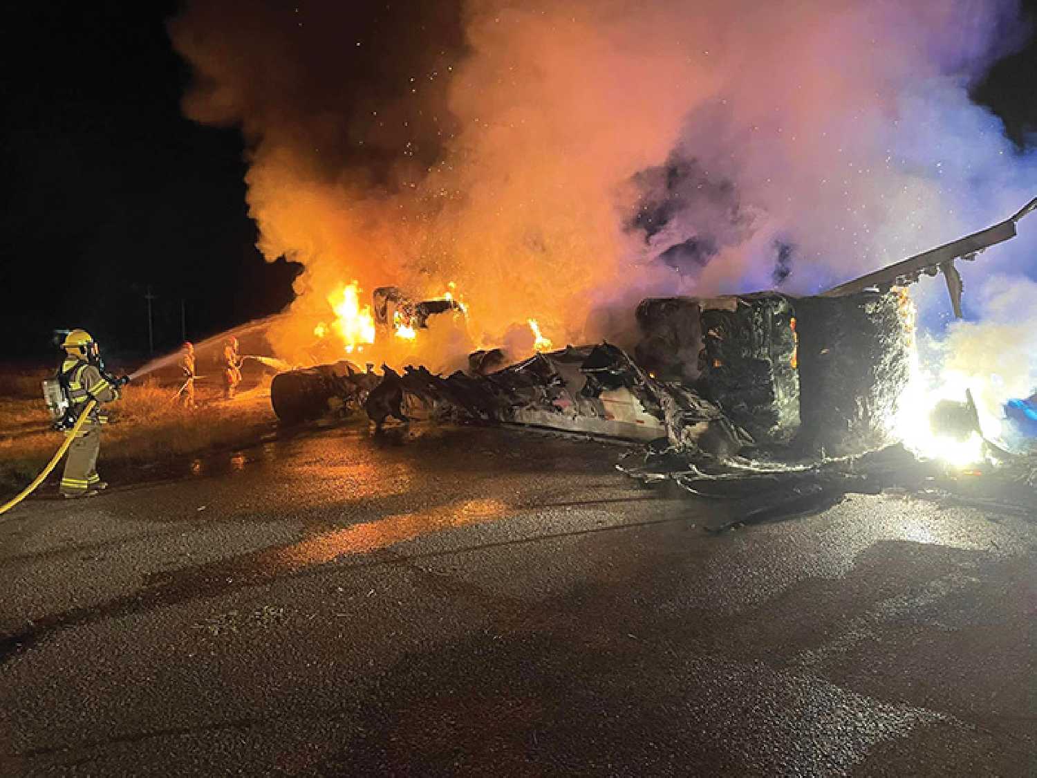 Firefighters dousing down a semi that was stolen and then started on fire while the drivers ran from police in the early morning hours on Sept. 30. Two suspects were taken into custody and charged with a long list of charges, including robbery, kidnapping, assault, and flight from police. The semi was carrying newsprint.